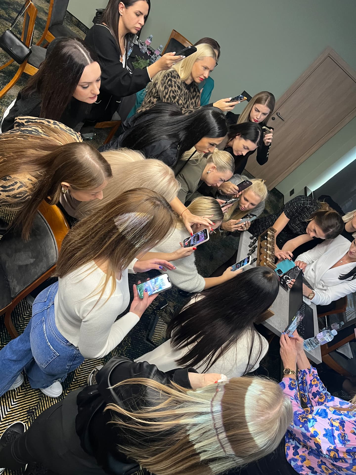 Full audience taking notes at a permanent makeup seminar